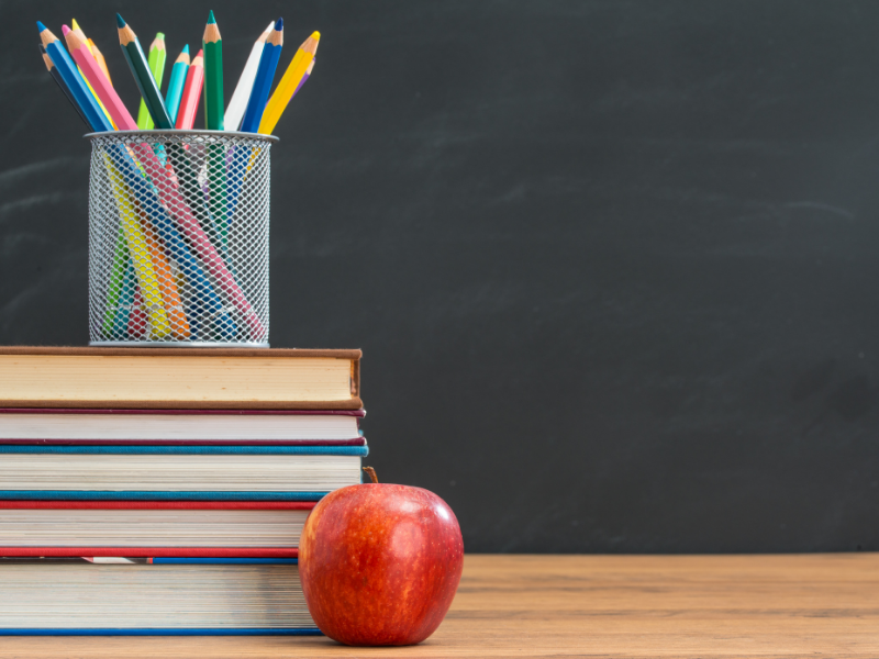 Apple, books and pencils