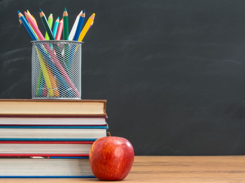 An apple with books