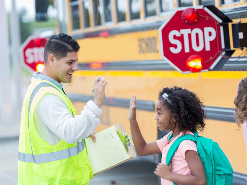 Staff member high-fiving student